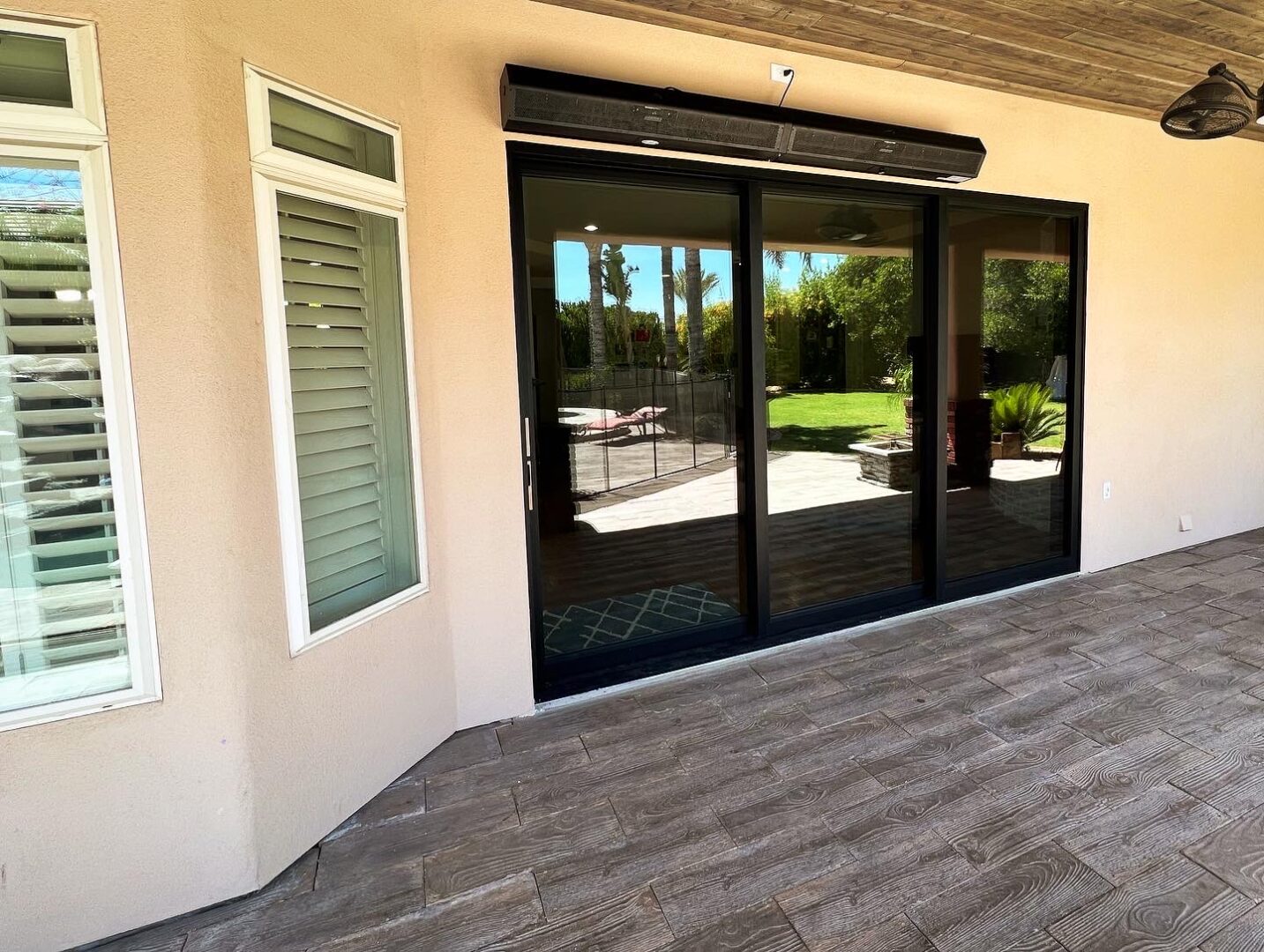 A sliding glass door in the middle of a patio.