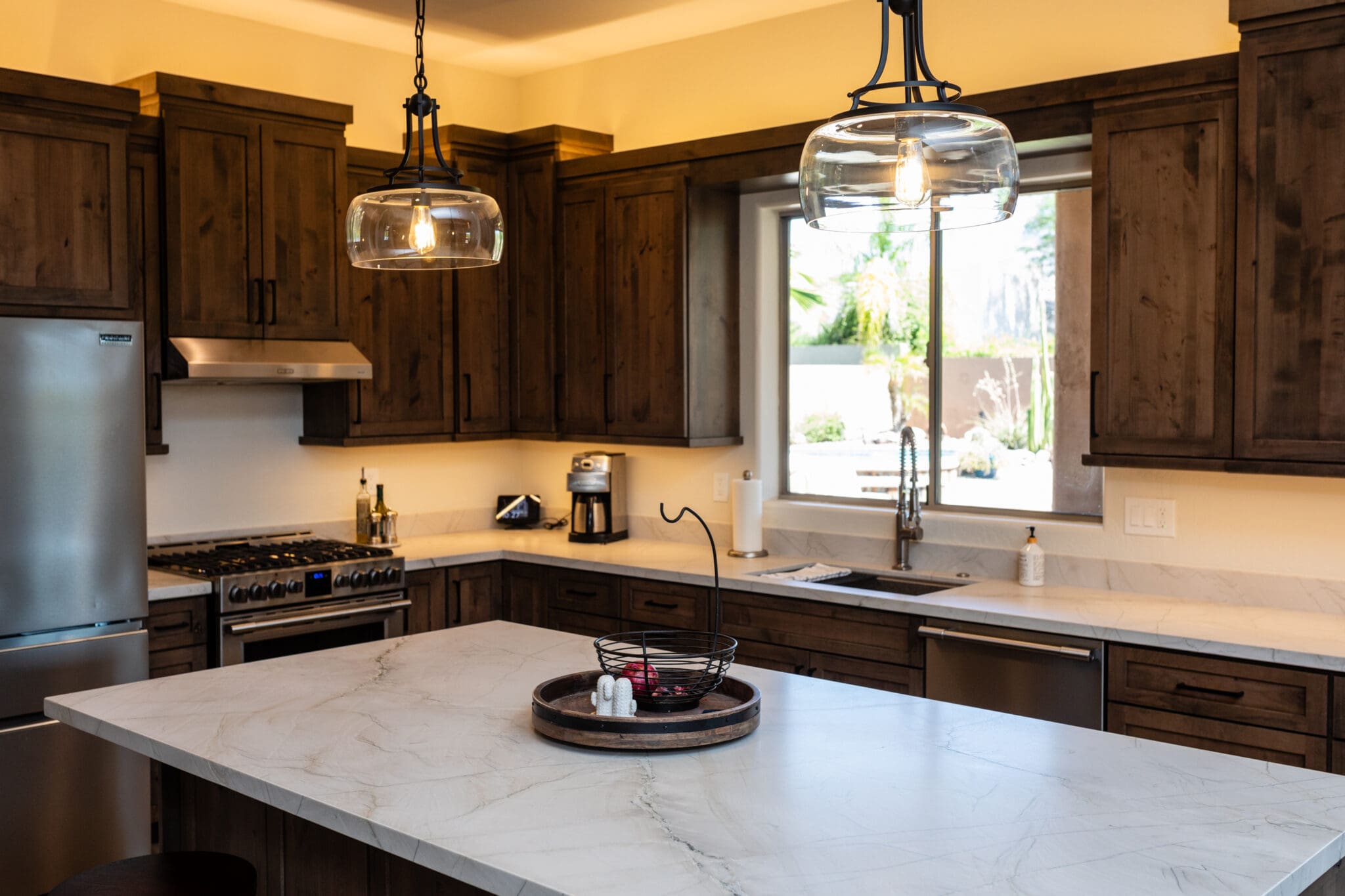 20230705_190742940_iOS-2048x1365-1 Arizona kitchen remodel with large waterfall island, custom cabinetry, and pendant lighting