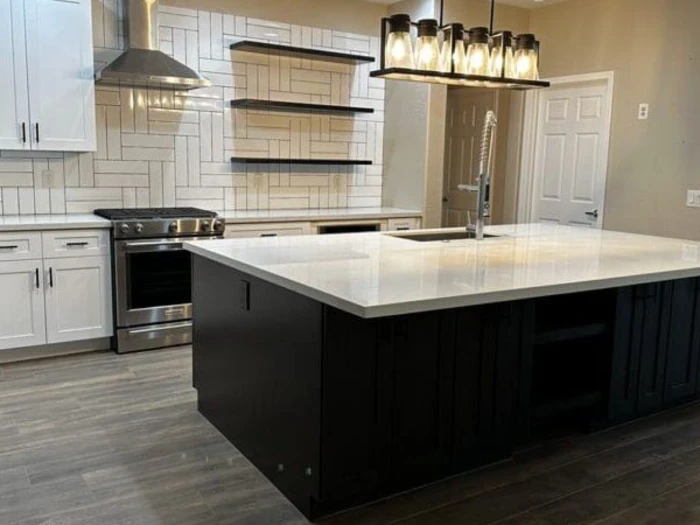 custom cabinetry2 Remodeled bathroom with double vanity, granite countertops, white cabinetry, and glass shower.