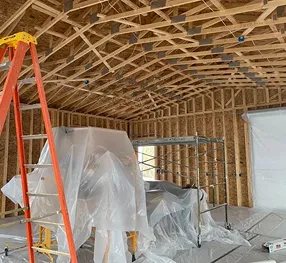 phase3 Home remodeling project under construction with exposed wood framing and ceiling trusses