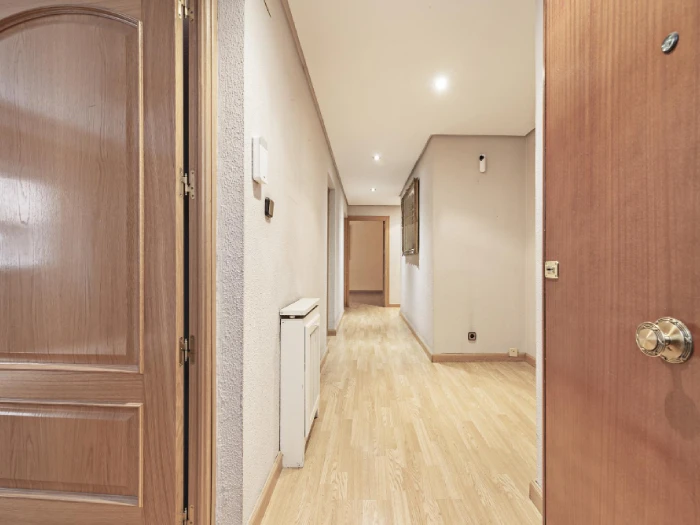 separate entrance Remodeled bathroom with double vanity, granite countertops, white cabinetry, and glass shower.