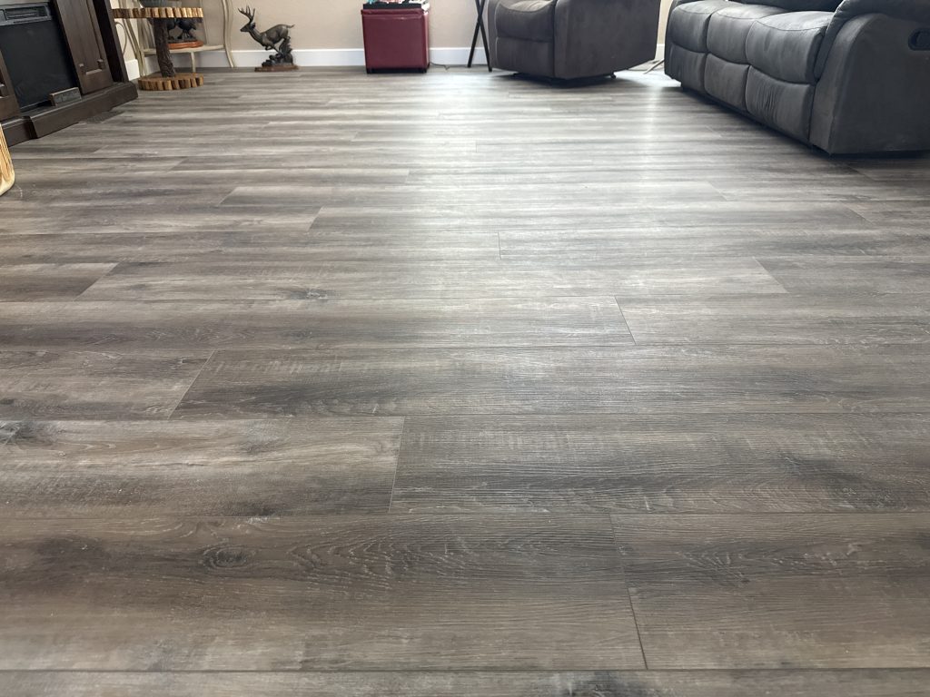 New wood-look plank flooring installed throughout a residential living room