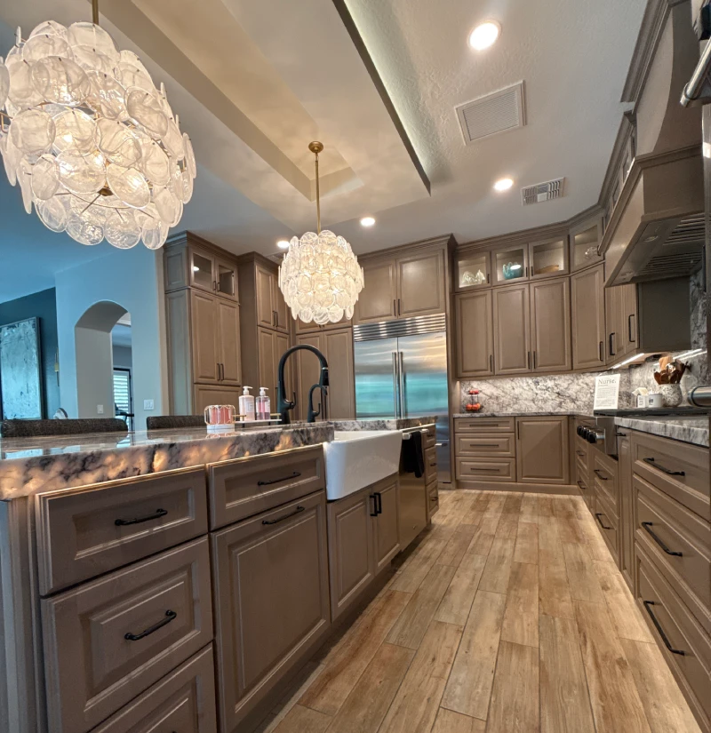 Stornghold-about2 Full kitchen remodel with custom cabinetry, stone countertops, farmhouse sink, and modern pendant lighting